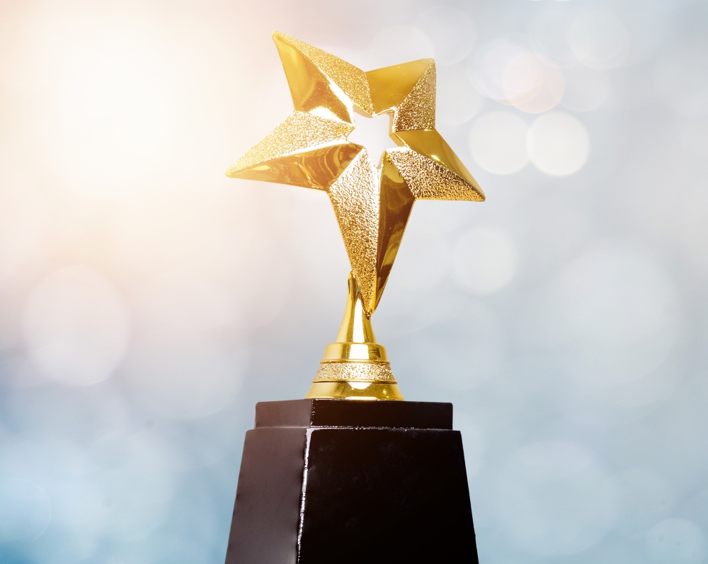 Soft focus background with award with black base and gold star top